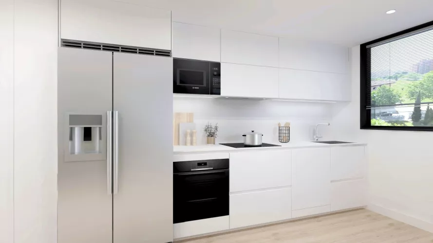 Cocina con isla compacta, diseñada para potenciar la luminosidad y la vida social en un espacio contemporáneo