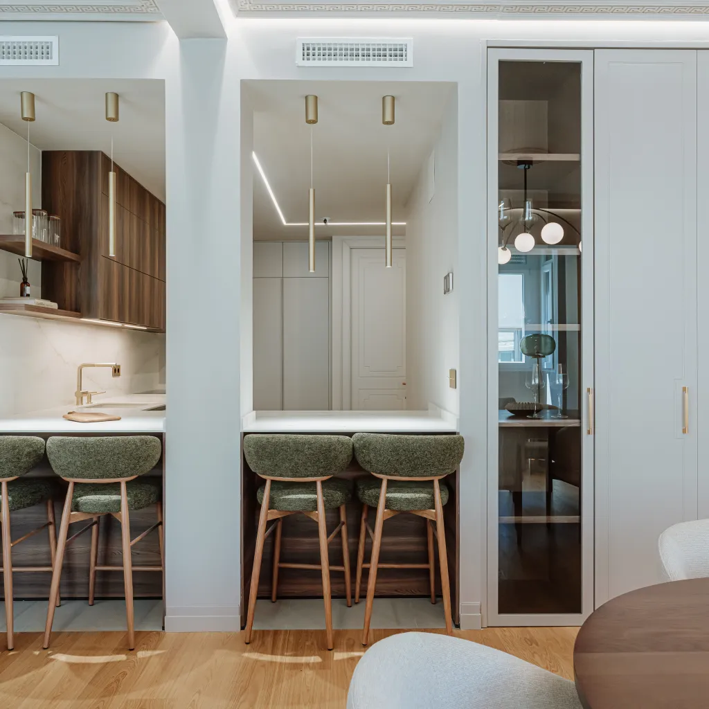 Cocina contemporánea con madera oscura, tonos neutros y detalles dorados
