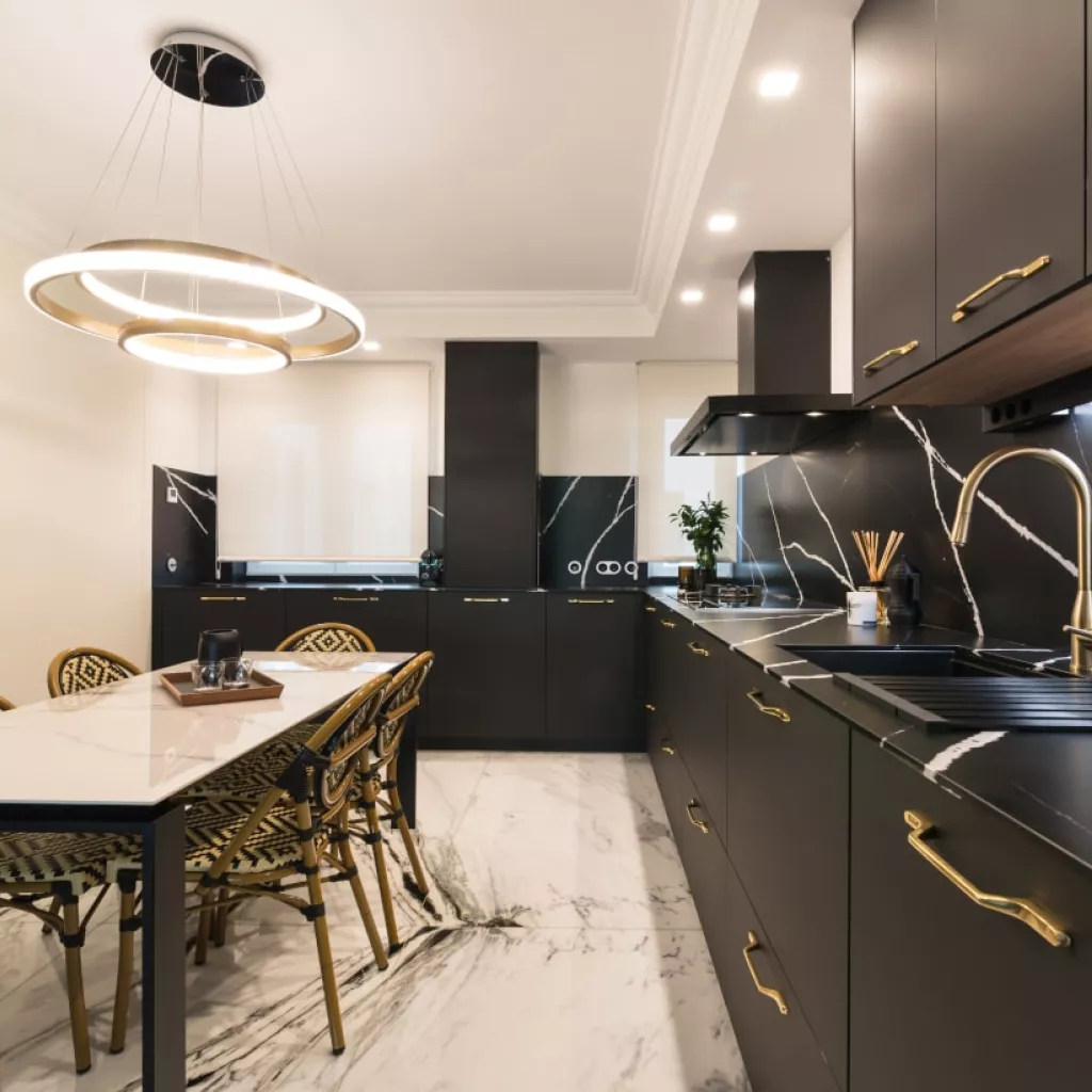 Cocina Santos negra con forma L y mesa central